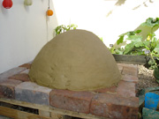 Covering the sand form with clay